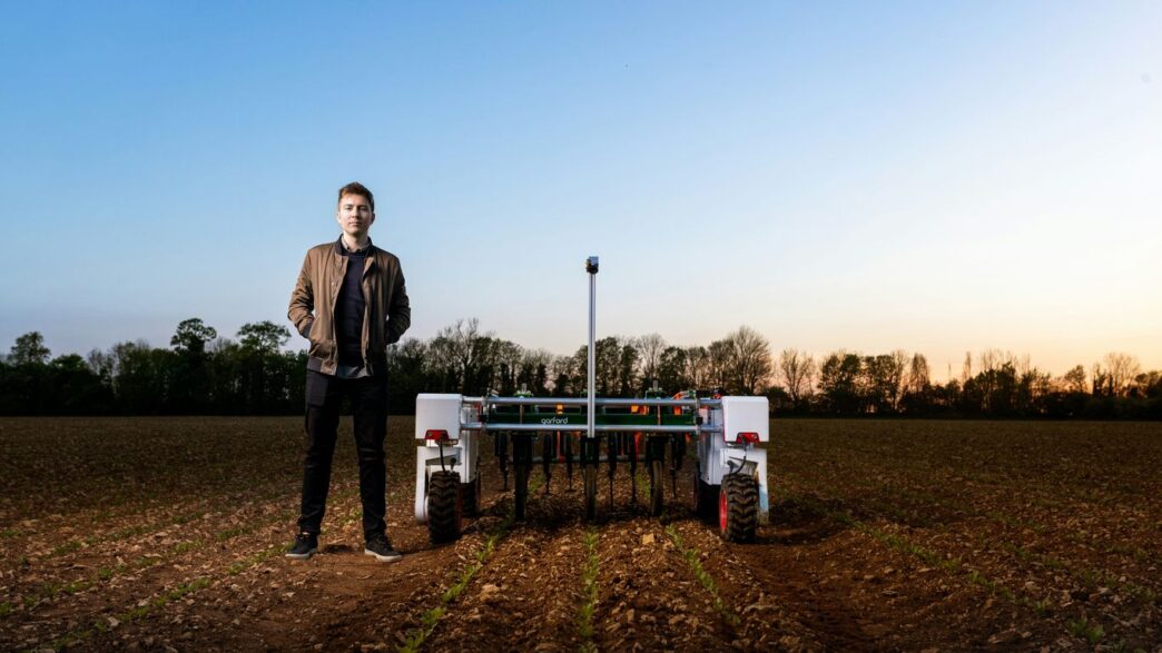 man in black jacket standing on green grass field during daytime