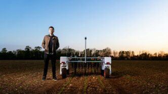 man in black jacket standing on green grass field during daytime