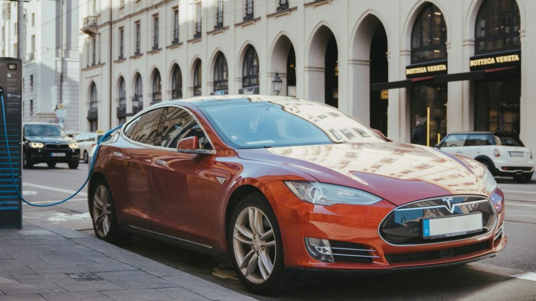 blue porsche 911 parked on sidewalk during daytime