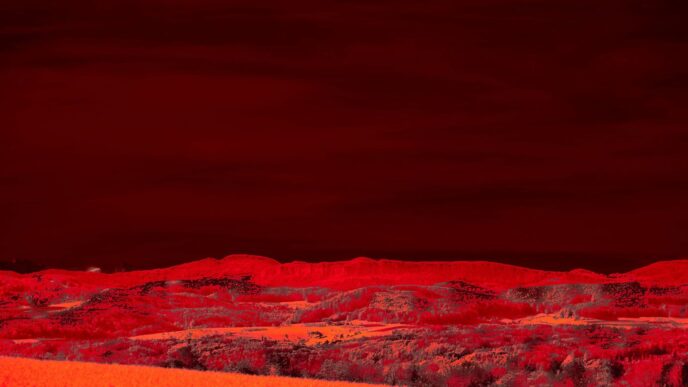 Red landscape with rolling hills and dark sky