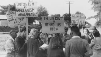 Protesters hold signs supporting unionism and demanding a contract.