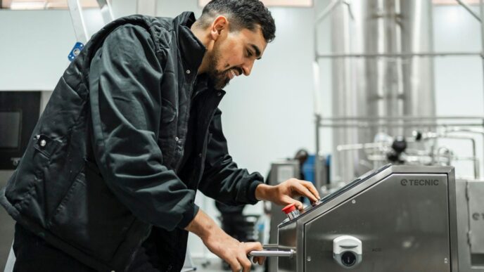 A man operates equipment in an industrial setting.