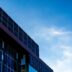 Modern building facade with solar panels against blue sky