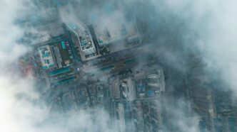 Aerial view of buildings partially covered by clouds