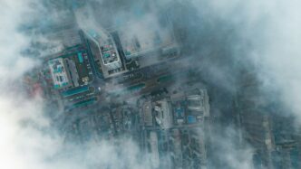 Aerial view of buildings partially covered by clouds