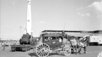 grayscale photo of people riding on carriage