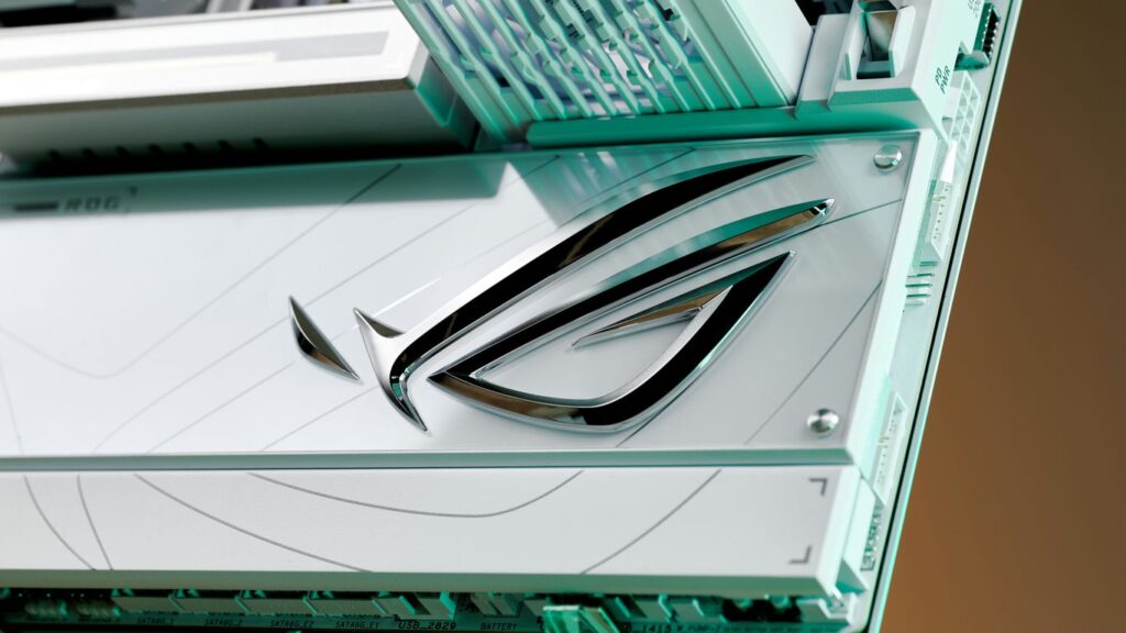 Close-up of a chrome logo on a white surface.