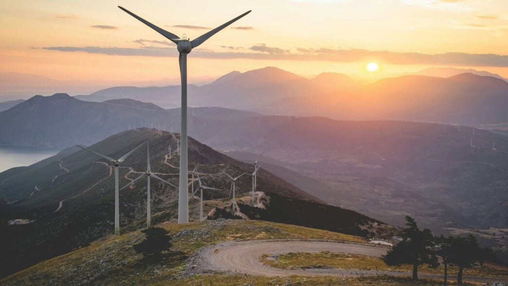 wind turbine on hill during daytime