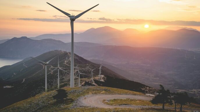 wind turbine on hill during daytime