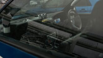 Interior view of a blue car with gauges.