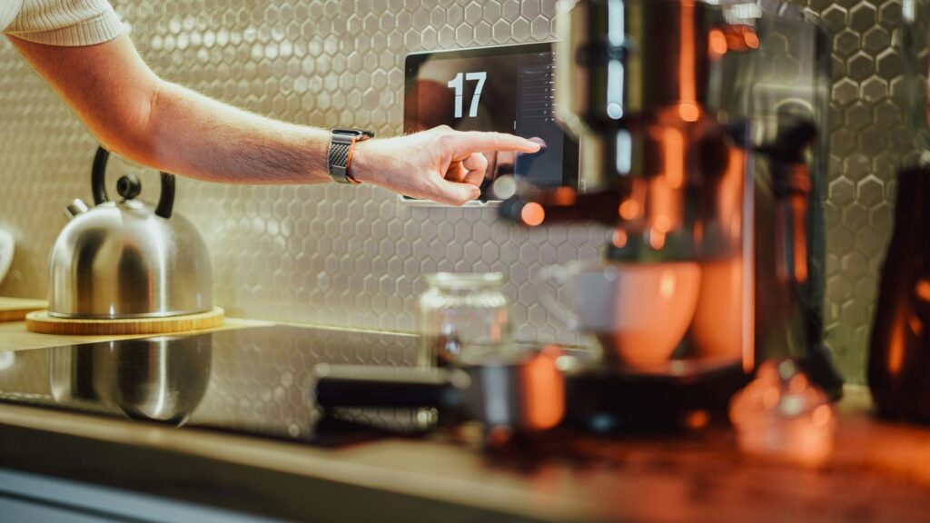 a person pressing a button on a coffee machine