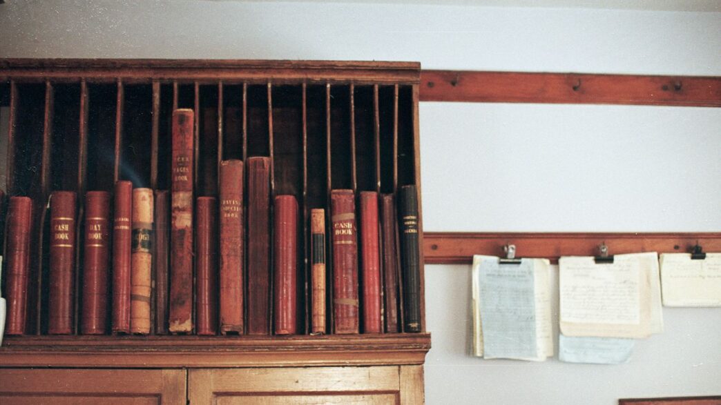 Wooden shelf filled with antique books