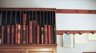 Wooden shelf filled with antique books