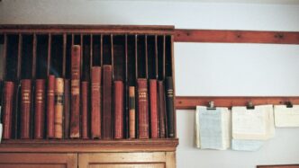 Wooden shelf filled with antique books