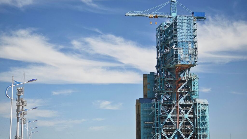 a tall building with a crane on top of it