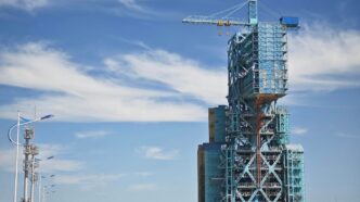 a tall building with a crane on top of it