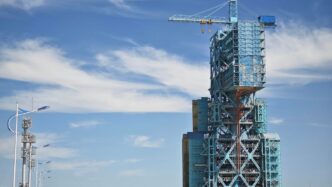 a tall building with a crane on top of it