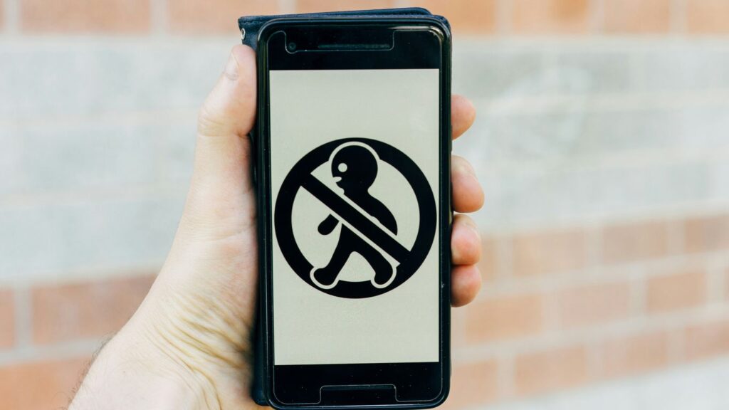 person holding black smartphone with black and white case