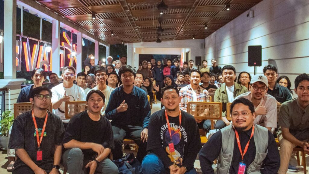 A diverse group of people gathered indoors for an event.