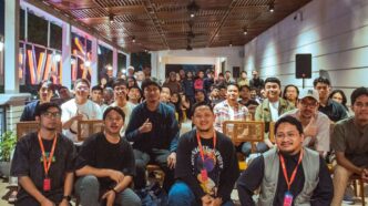 A diverse group of people gathered indoors for an event.