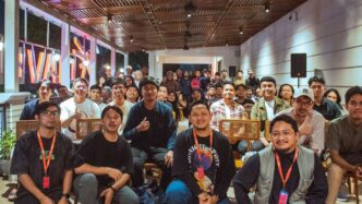 A diverse group of people gathered indoors for an event.