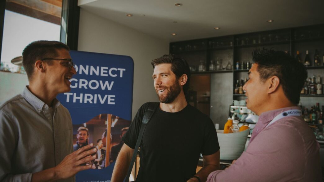 a group of three men standing next to each other