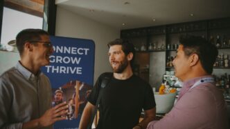 a group of three men standing next to each other
