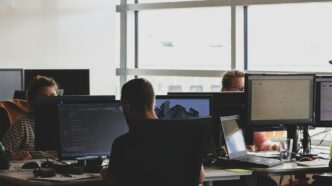 people sitting on chairs and using computers