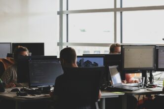people sitting on chairs and using computers