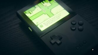 A handheld console displays a map on its screen.