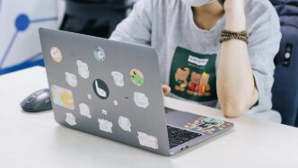 woman in white hijab using macbook pro