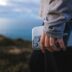 Person holding a smartphone on a scenic overlook