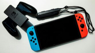 white nintendo switch beside black usb flash drive
