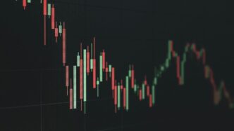 Stock market chart shows a declining trend.
