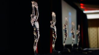 Several clear statuettes stand in a row.