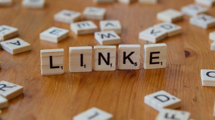 A wooden table topped with scrabble tiles spelling the word link