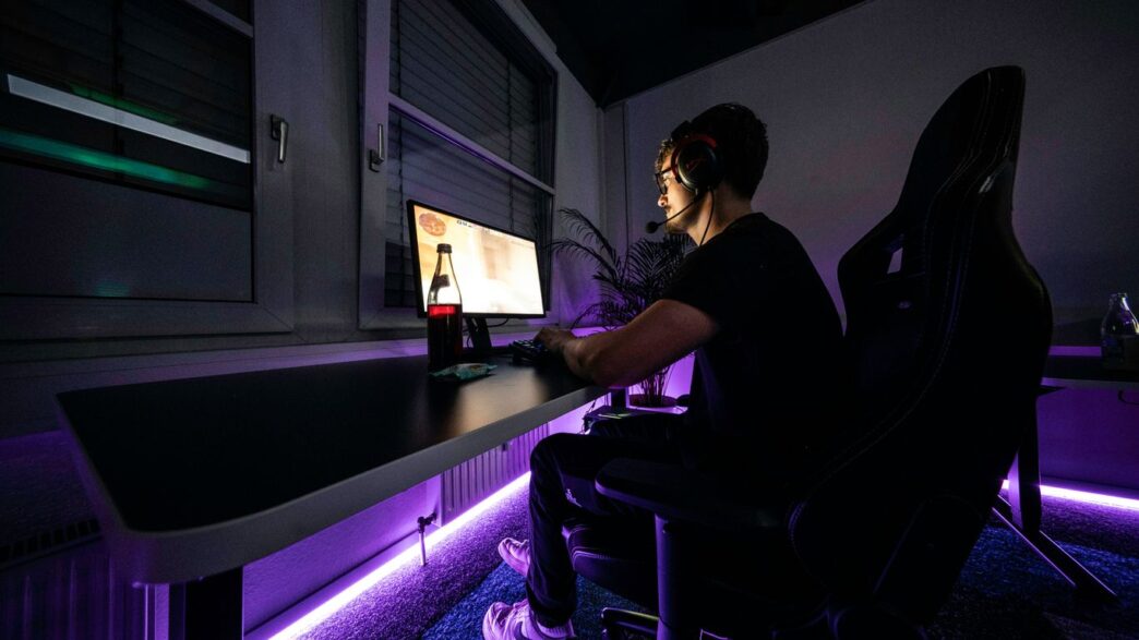 A man sitting at a desk with a computer in front of him