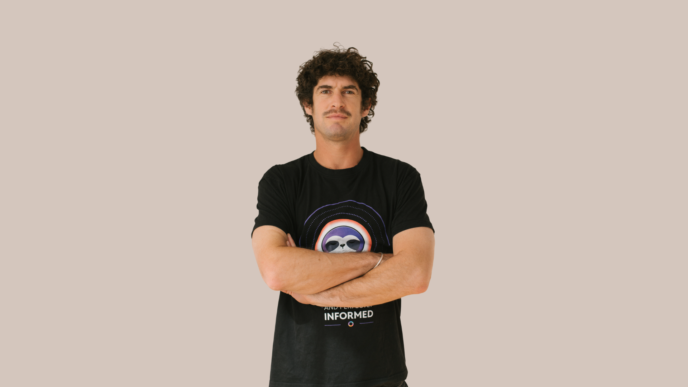 man posing in front of cream wall