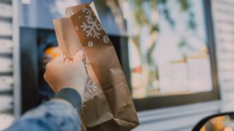 person holding a paper bag