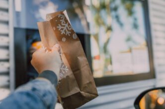 person holding a paper bag