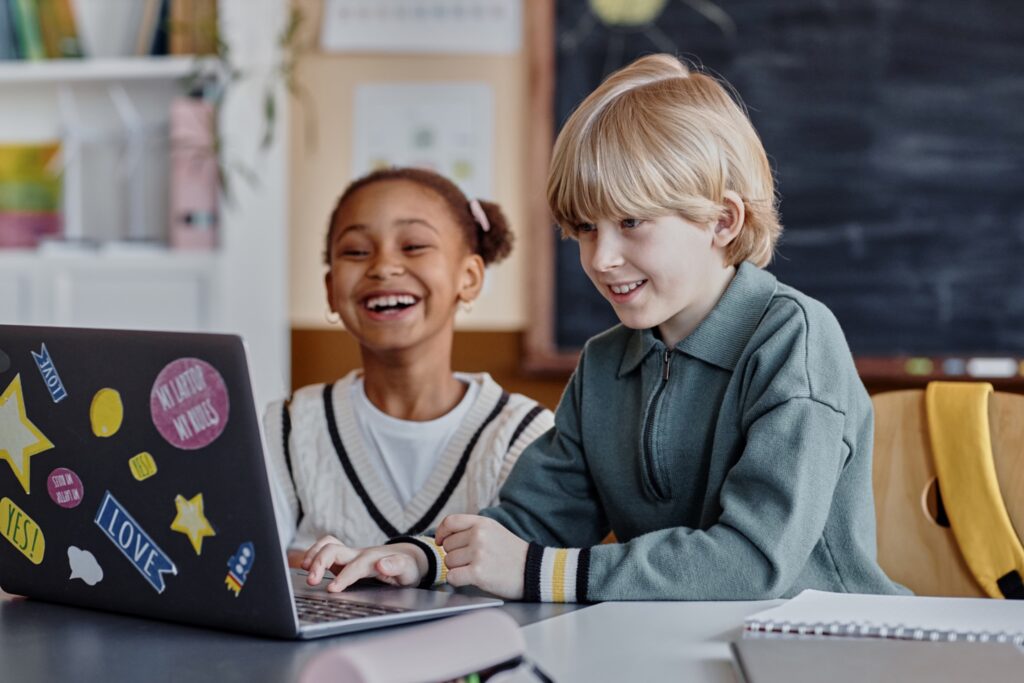 two children using a laptop