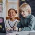 two children using a laptop